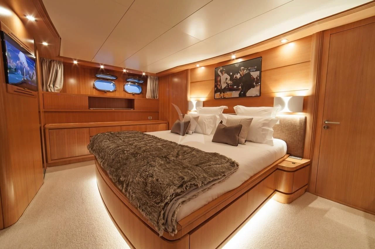 a bed in a room aboard FASTER Yacht for Sale