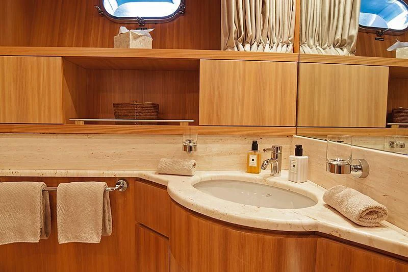 a bathroom with a sink and towels aboard FASTER Yacht for Sale