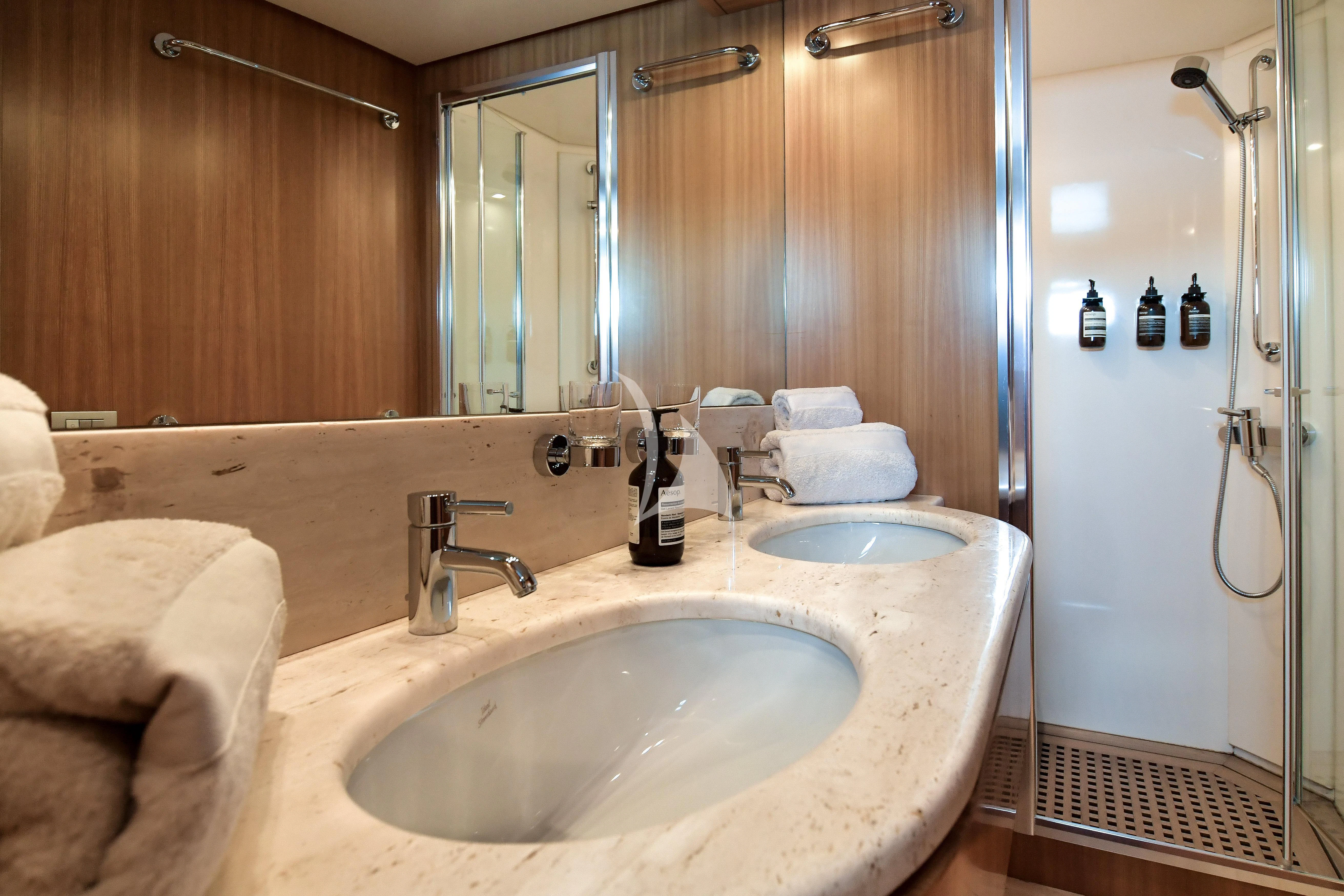 a bathroom with two sinks aboard FASTER Yacht for Sale