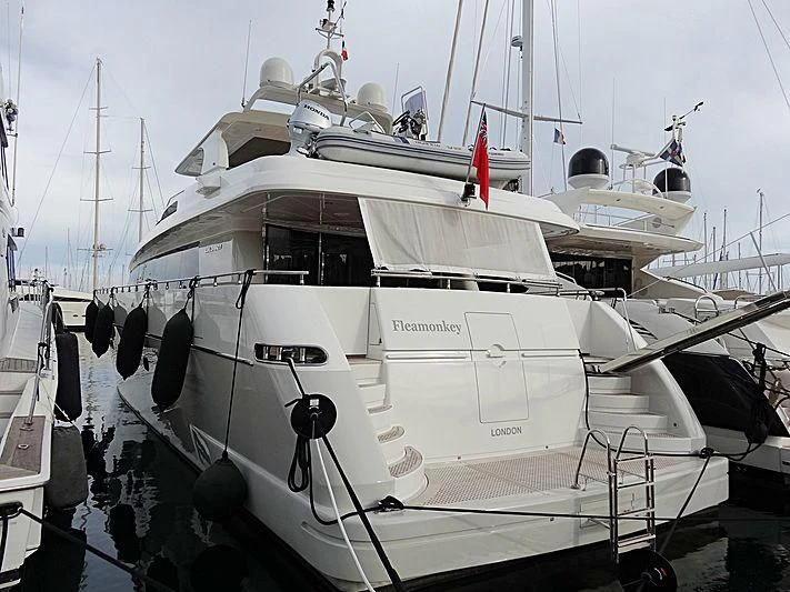 a white boat with black wheels aboard FASTER Yacht for Sale