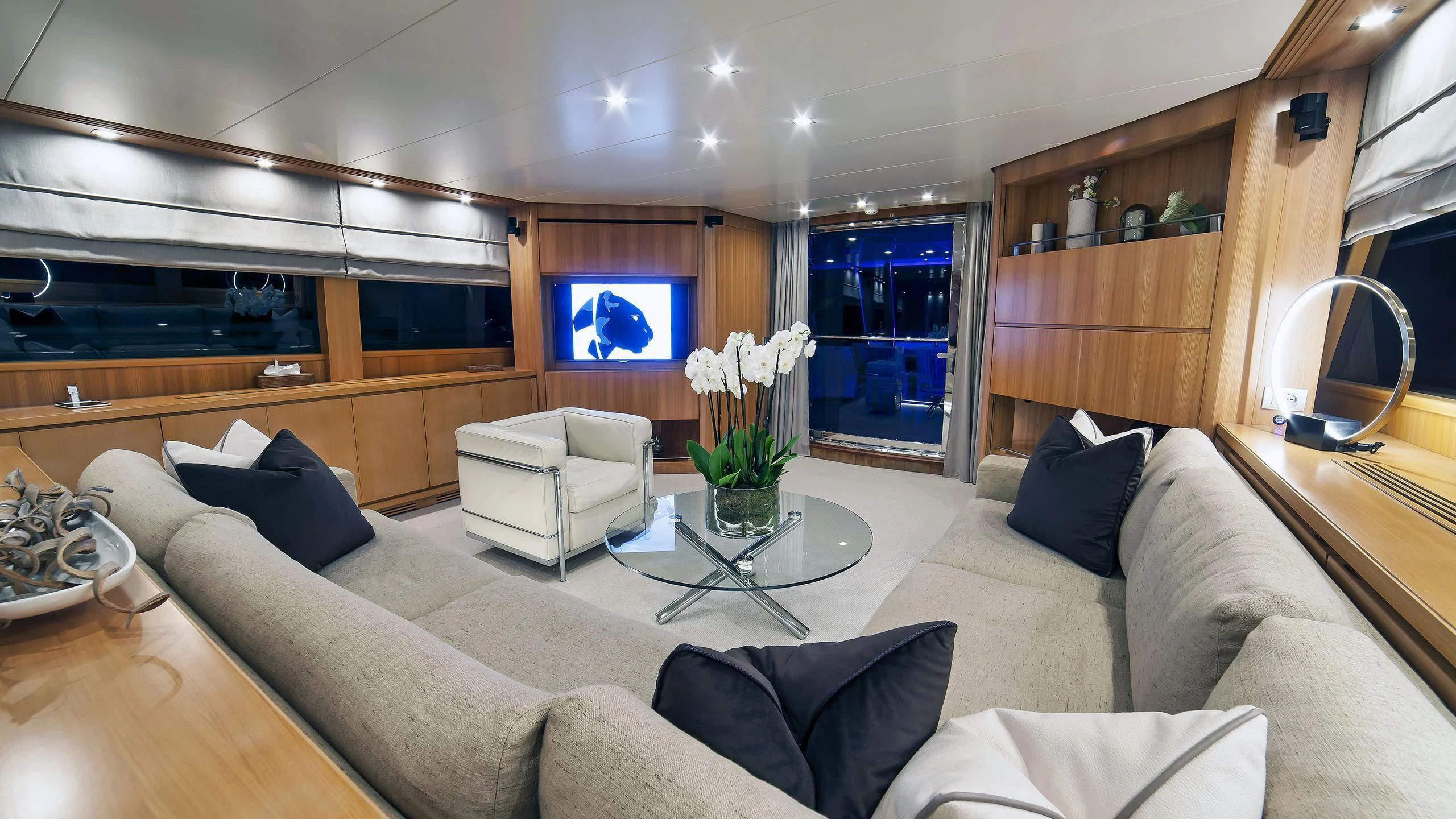 a living room with a large sofa aboard FASTER Yacht for Sale