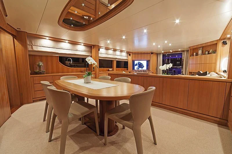 a kitchen with a table and chairs aboard FASTER Yacht for Sale
