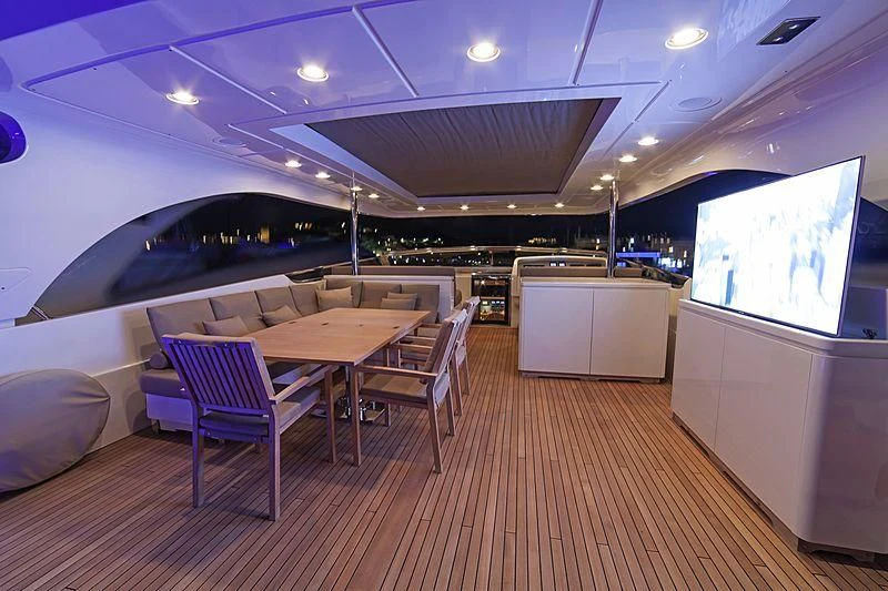 a room with a table and chairs aboard FASTER Yacht for Sale
