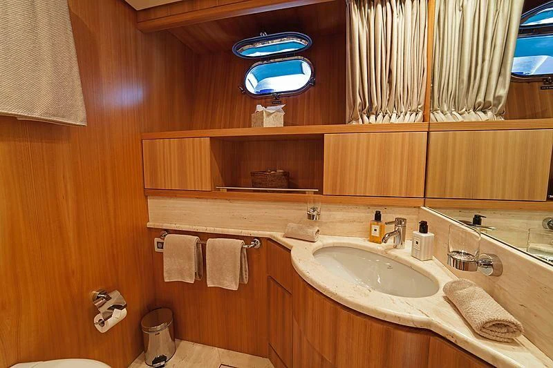 a bathroom with a large mirror aboard FASTER Yacht for Sale