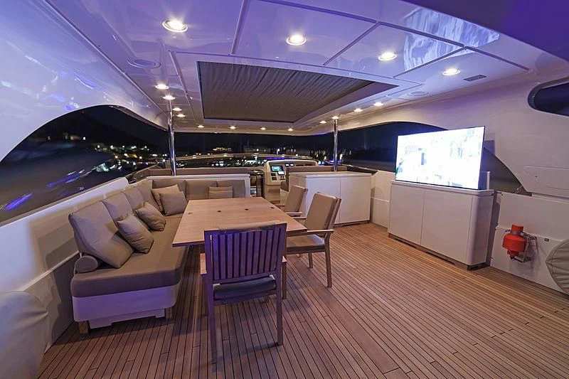 a room with a couch and a table and chairs aboard FASTER Yacht for Sale