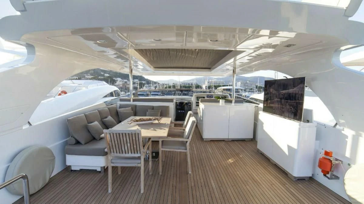 a room with a table chairs and a large window aboard FASTER Yacht for Sale