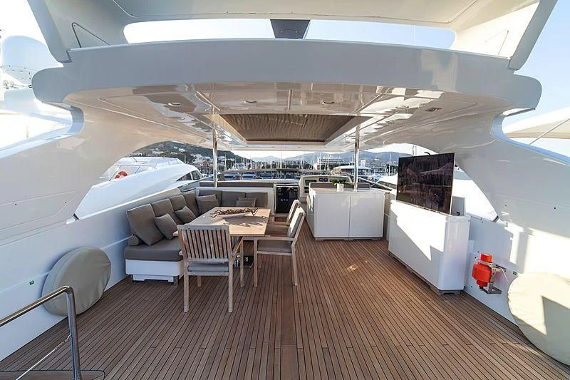 a room with a couch and a table and chairs aboard FASTER Yacht for Sale