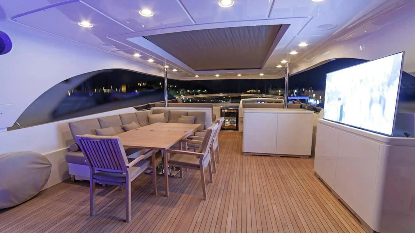 a room with a table and chairs aboard FASTER Yacht for Sale