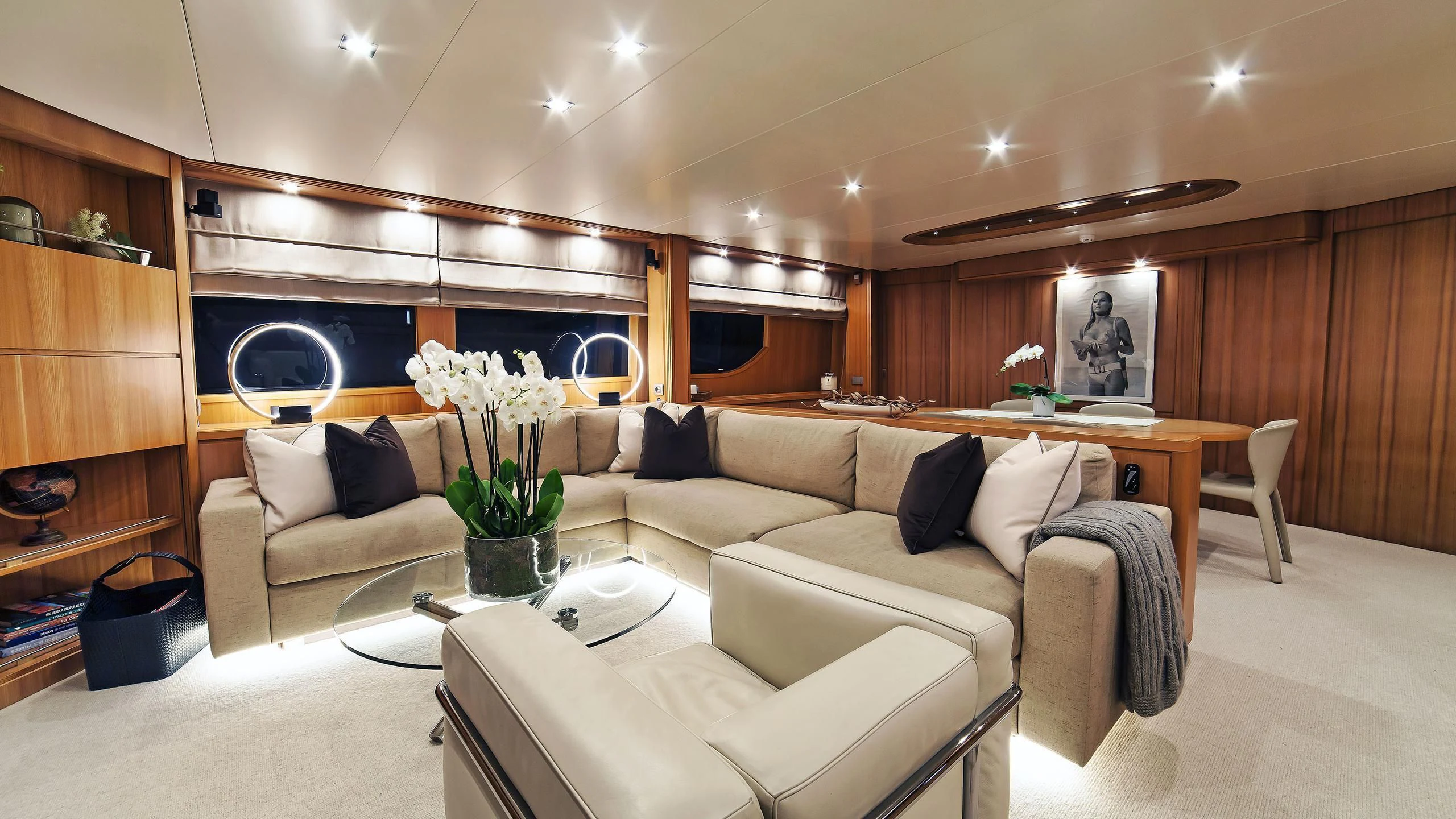 a living room with a white couch aboard FASTER Yacht for Sale