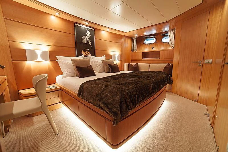 a large bed in a room aboard FASTER Yacht for Sale
