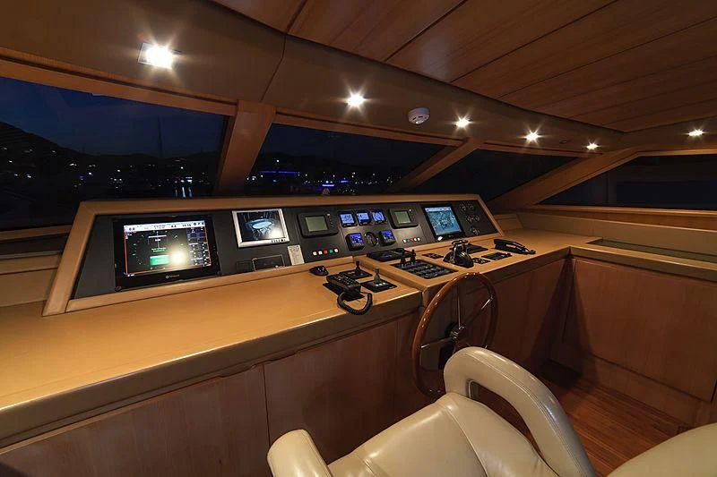 a room with a desk and chairs aboard FASTER Yacht for Sale