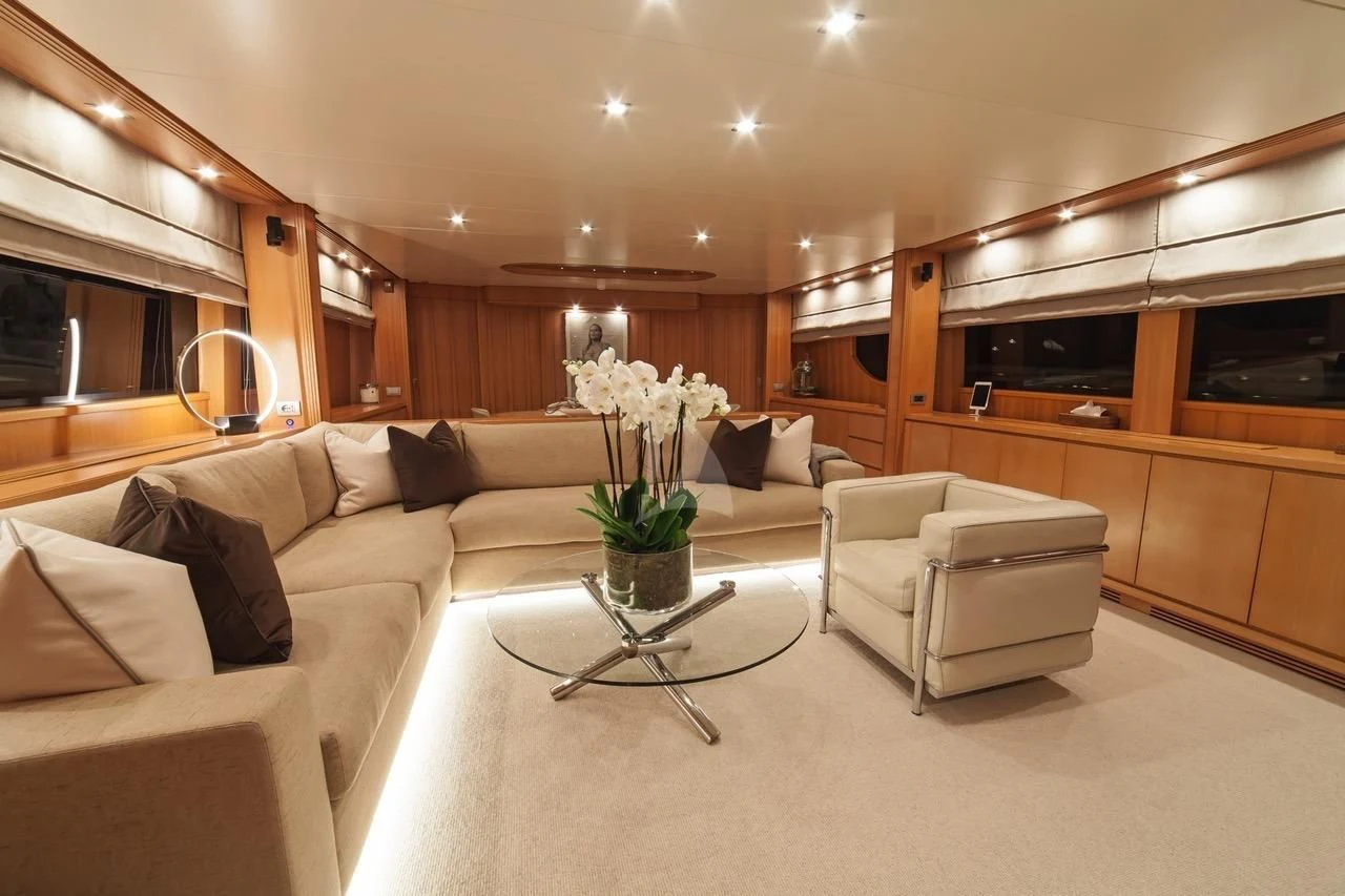 a living room with a large mirror aboard FASTER Yacht for Sale