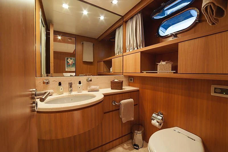 a bathroom with a large mirror aboard FASTER Yacht for Sale