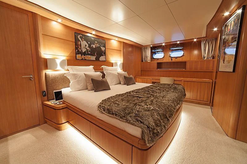 a hotel room with a bed aboard FASTER Yacht for Sale