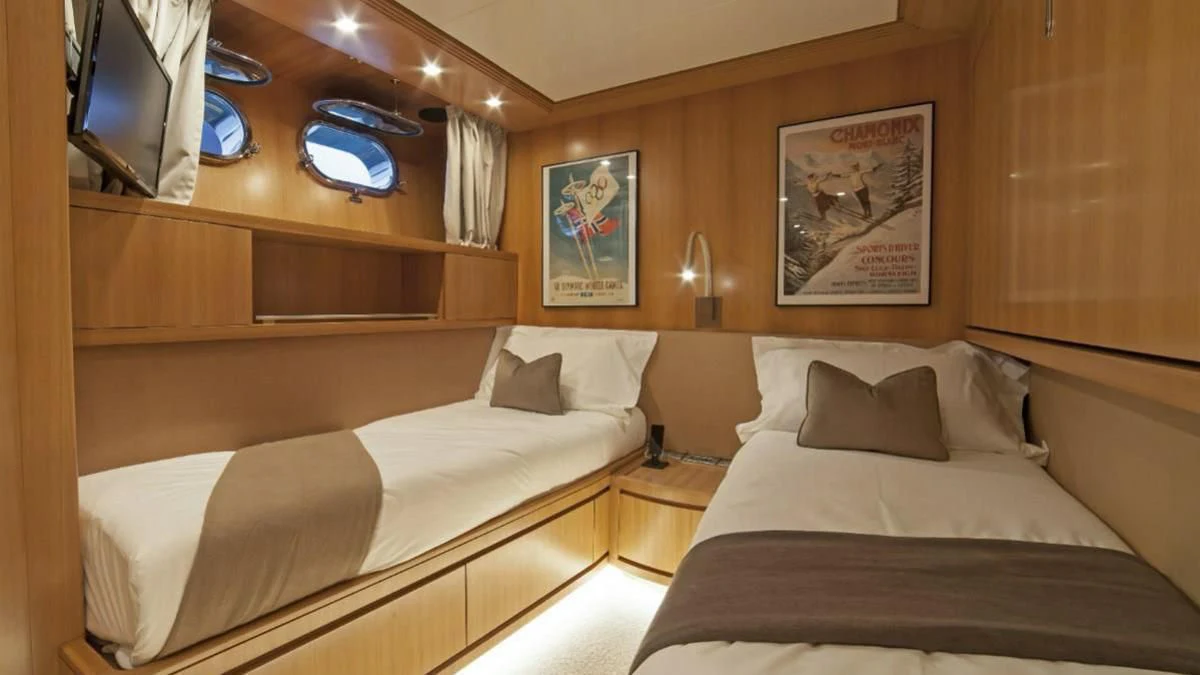 a room with two beds aboard FASTER Yacht for Sale