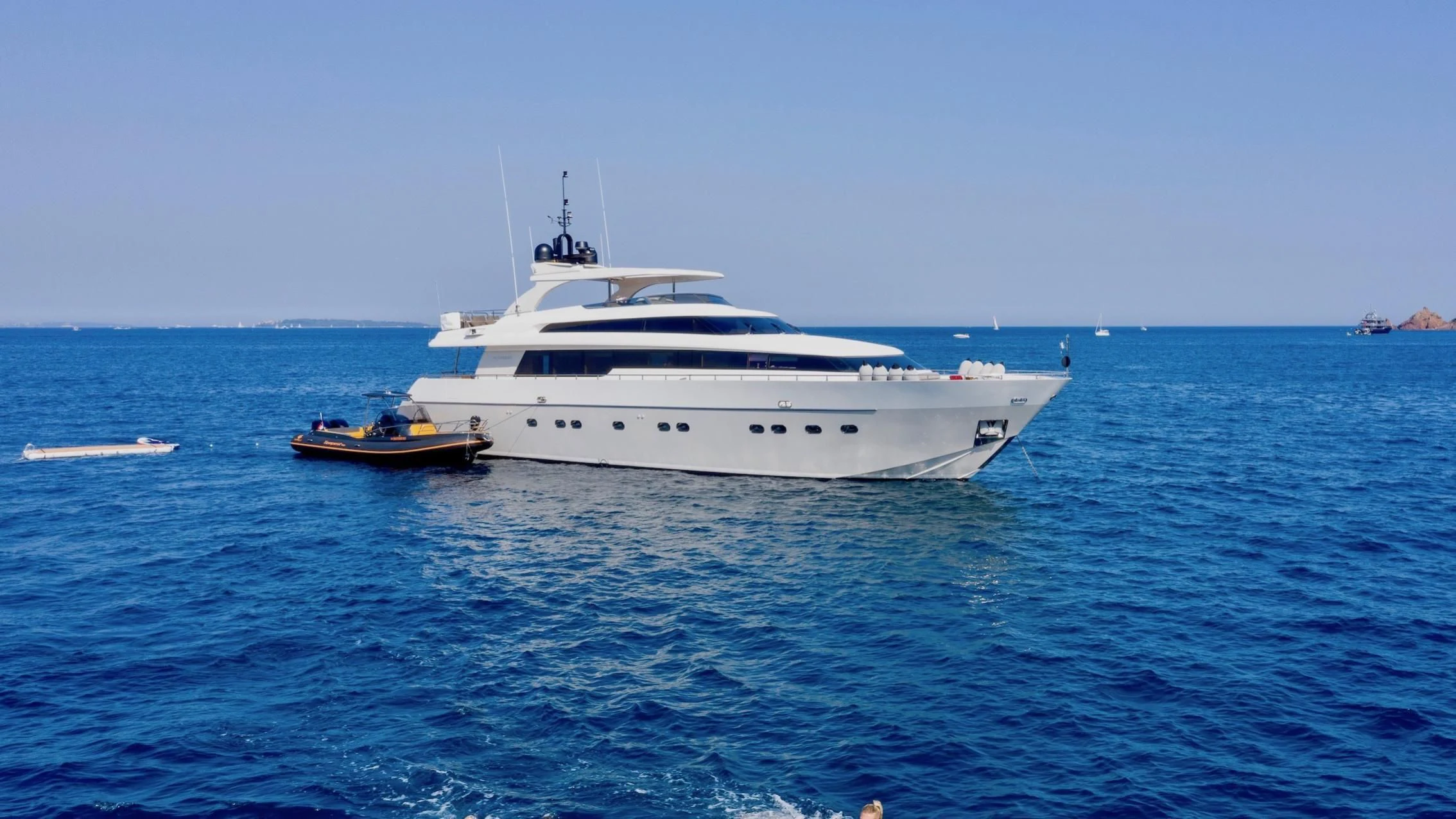 a white boat in the water aboard FASTER Yacht for Sale