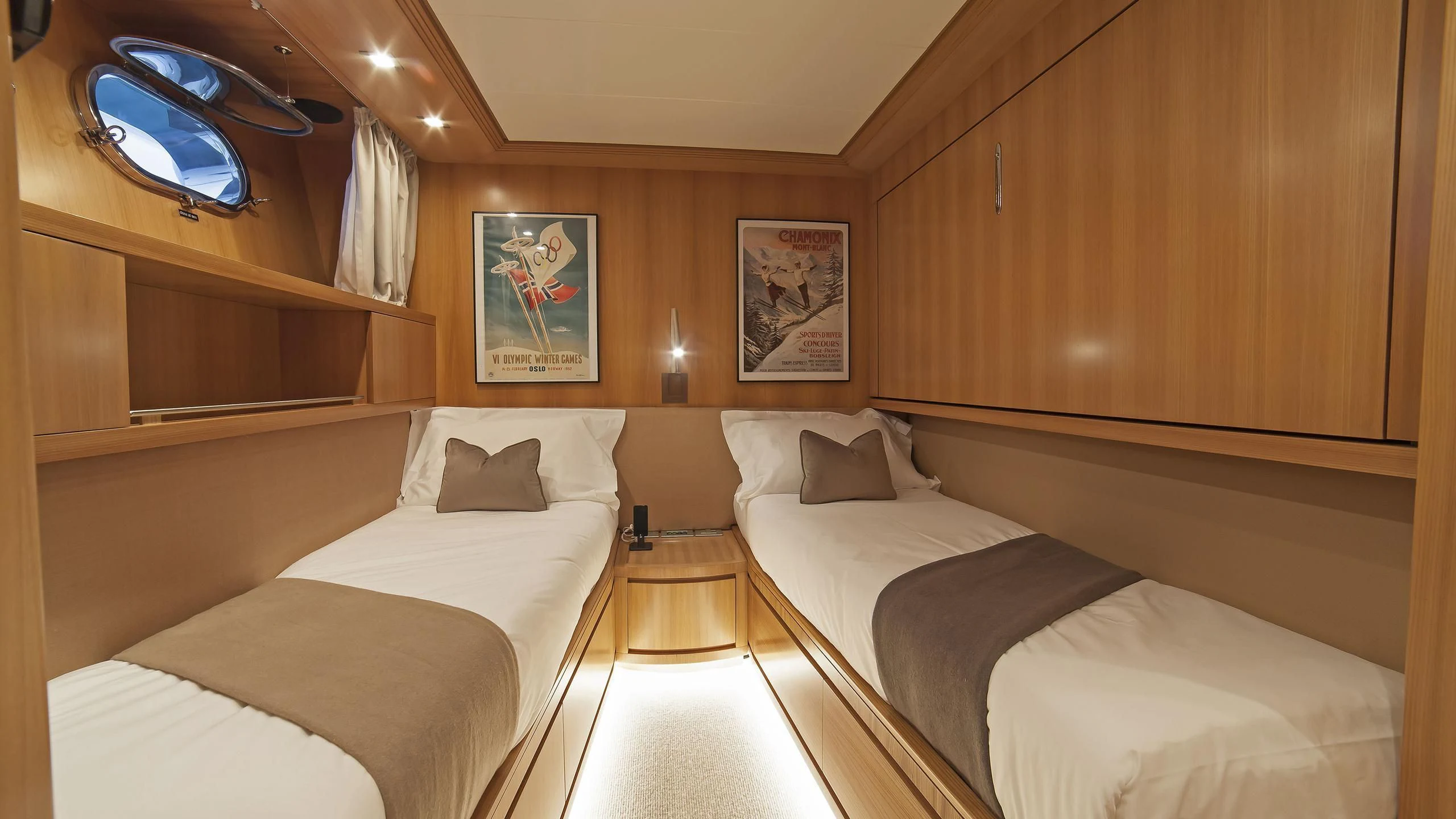 a room with a bed and a table aboard FASTER Yacht for Sale