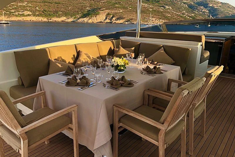 a table set for a dinner on a boat aboard FASTER Yacht for Sale