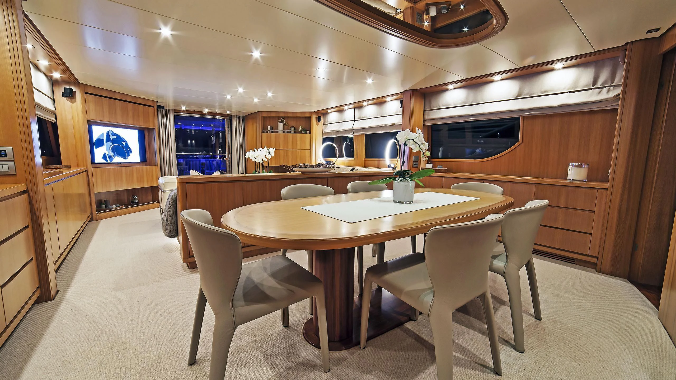 a table and chairs in a room aboard FASTER Yacht for Sale