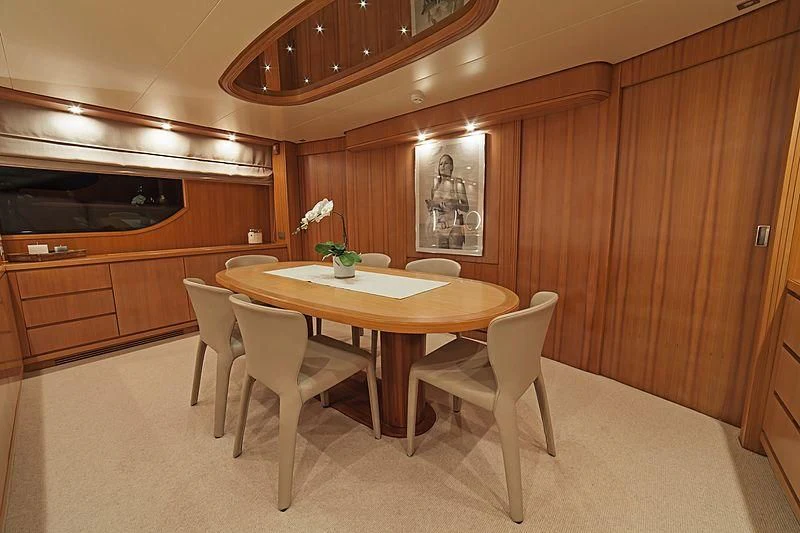 a kitchen with a table and chairs aboard FASTER Yacht for Sale