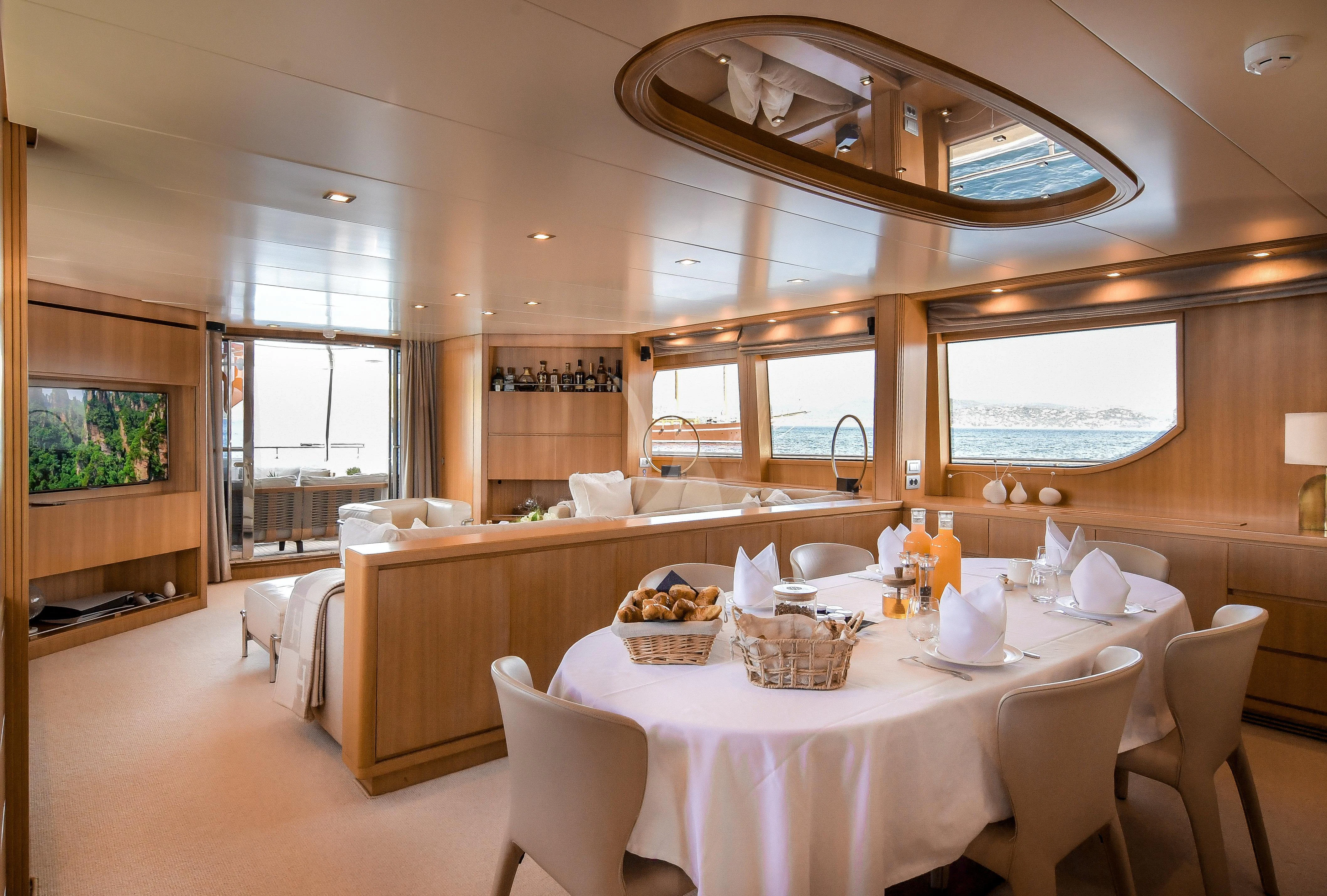a dining room with a table and chairs aboard FASTER Yacht for Sale