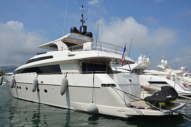 a white yacht with a black boat on the water aboard FASTER Yacht for Sale