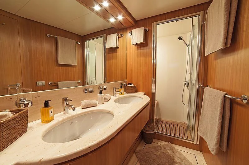 a bathroom with a sink and a shower aboard FASTER Yacht for Sale