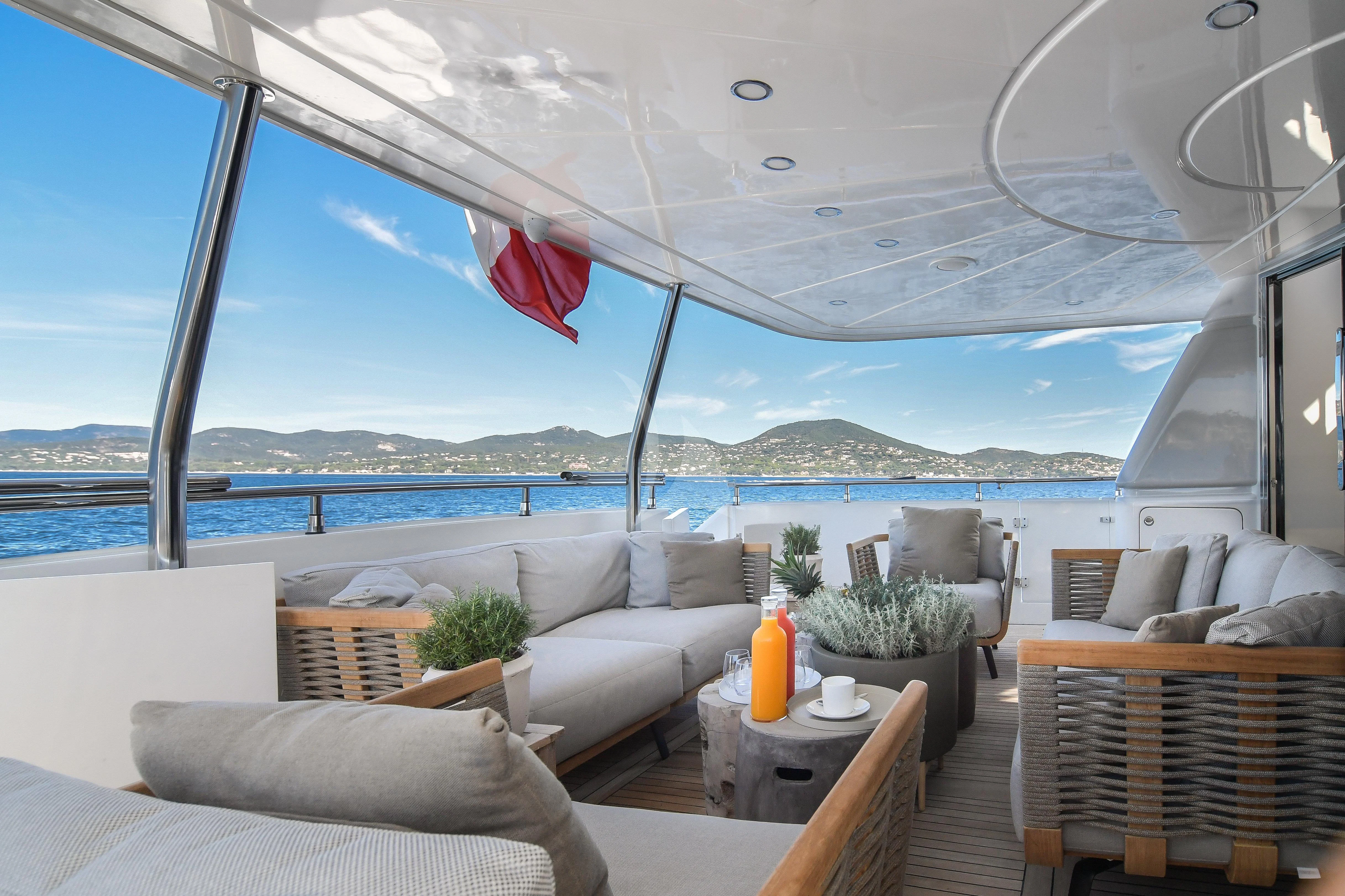 a room with a couch and a table and chairs aboard FASTER Yacht for Sale