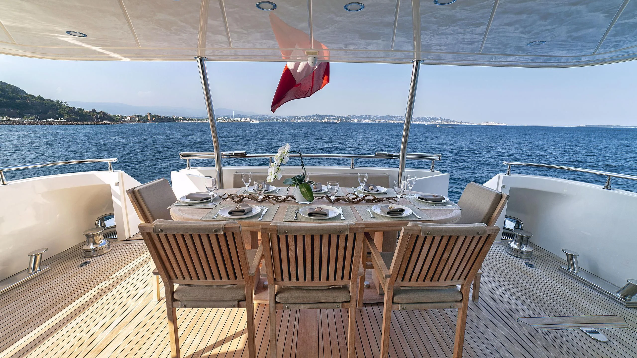 a table set for a meal on a boat aboard FASTER Yacht for Sale