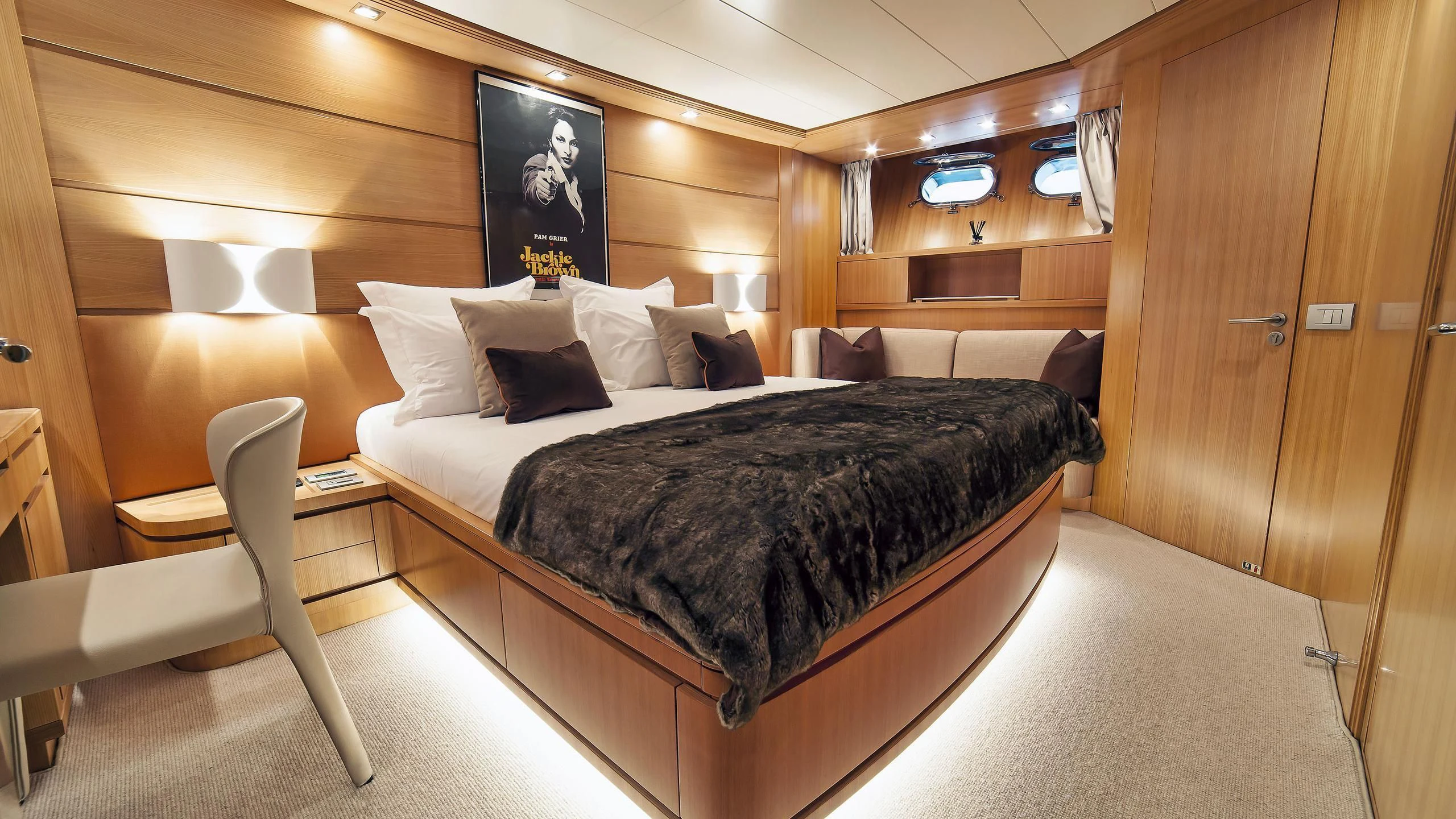 a bed with a black bed aboard FASTER Yacht for Sale