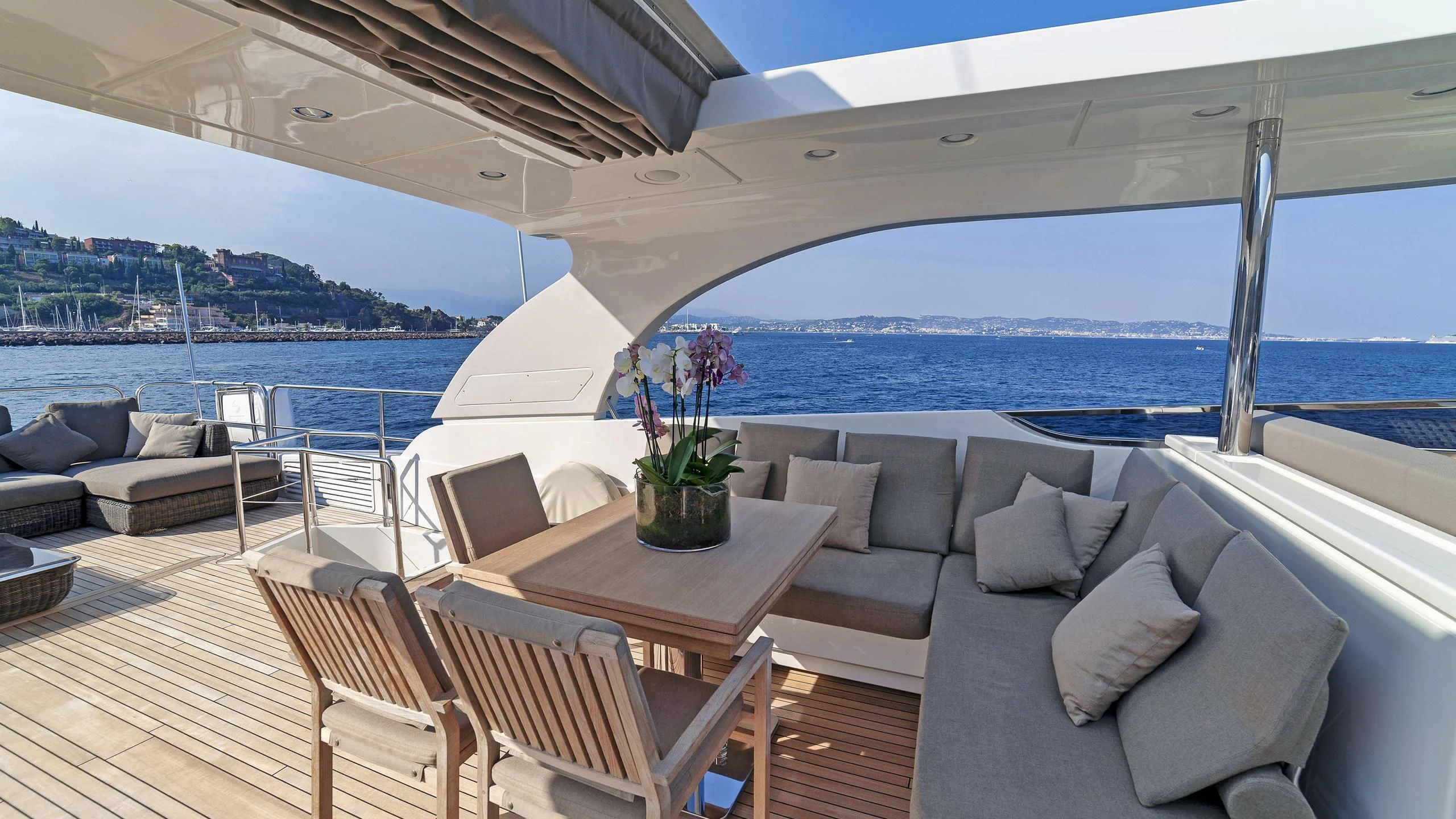 a large patio with a table and chairs on it aboard FASTER Yacht for Sale