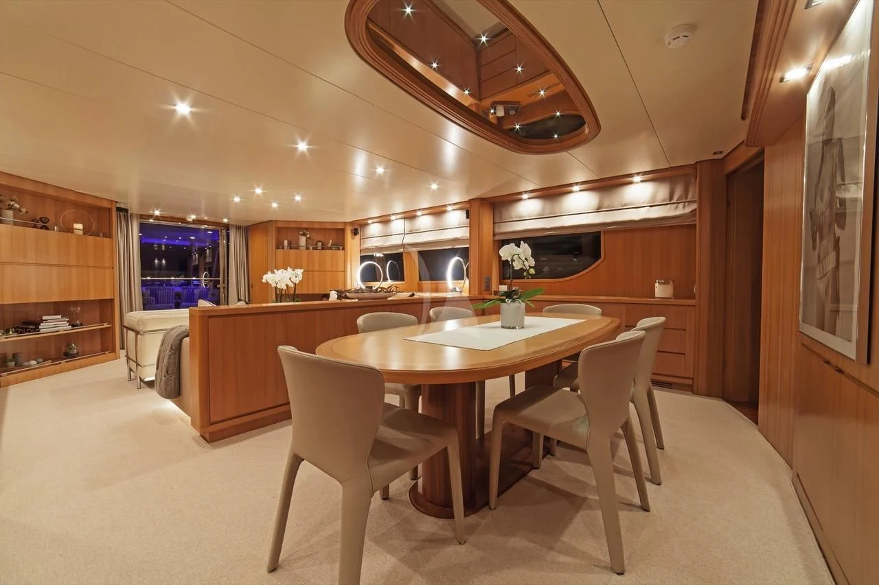 a kitchen with a table and chairs aboard FASTER Yacht for Sale