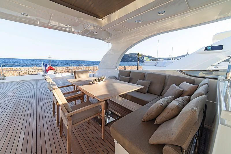 a living room with a couch and a table aboard FASTER Yacht for Sale