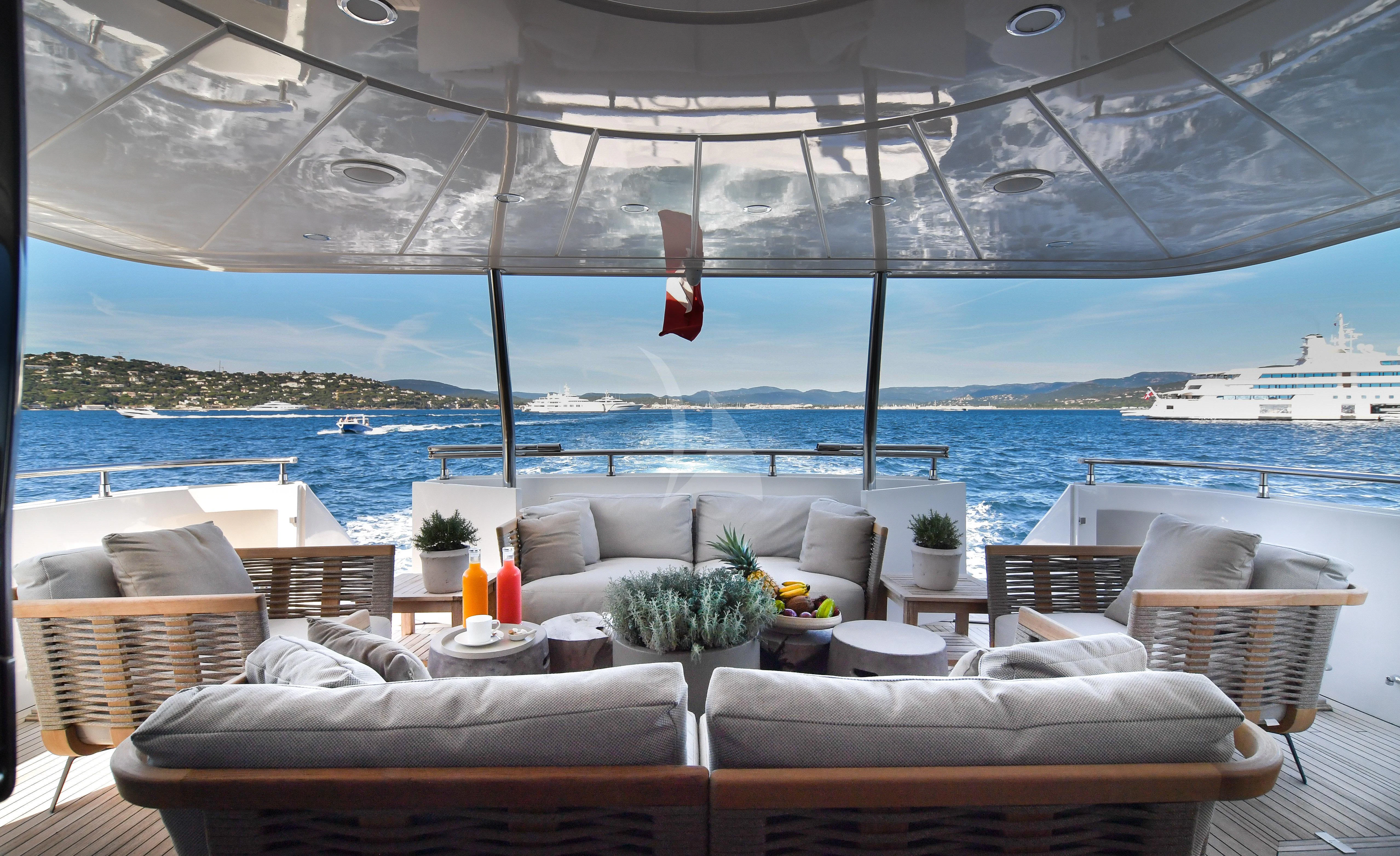 a room with couches and chairs aboard FASTER Yacht for Sale