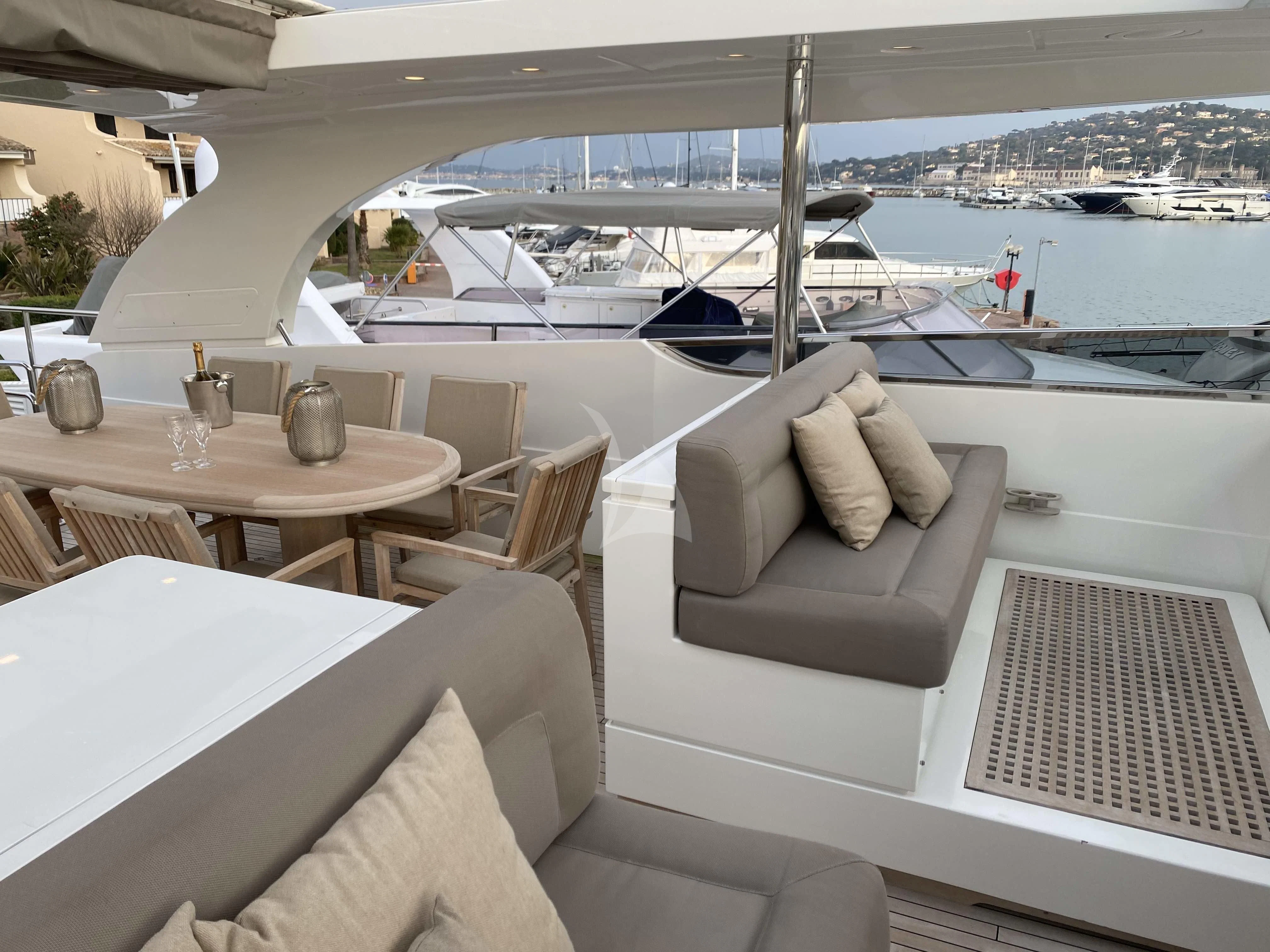 a room with a couch and a table and chairs aboard FASTER Yacht for Sale