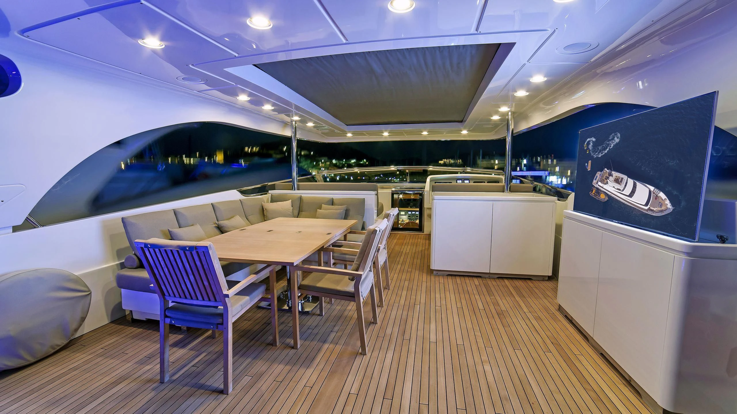 a room with a table and chairs aboard FASTER Yacht for Sale