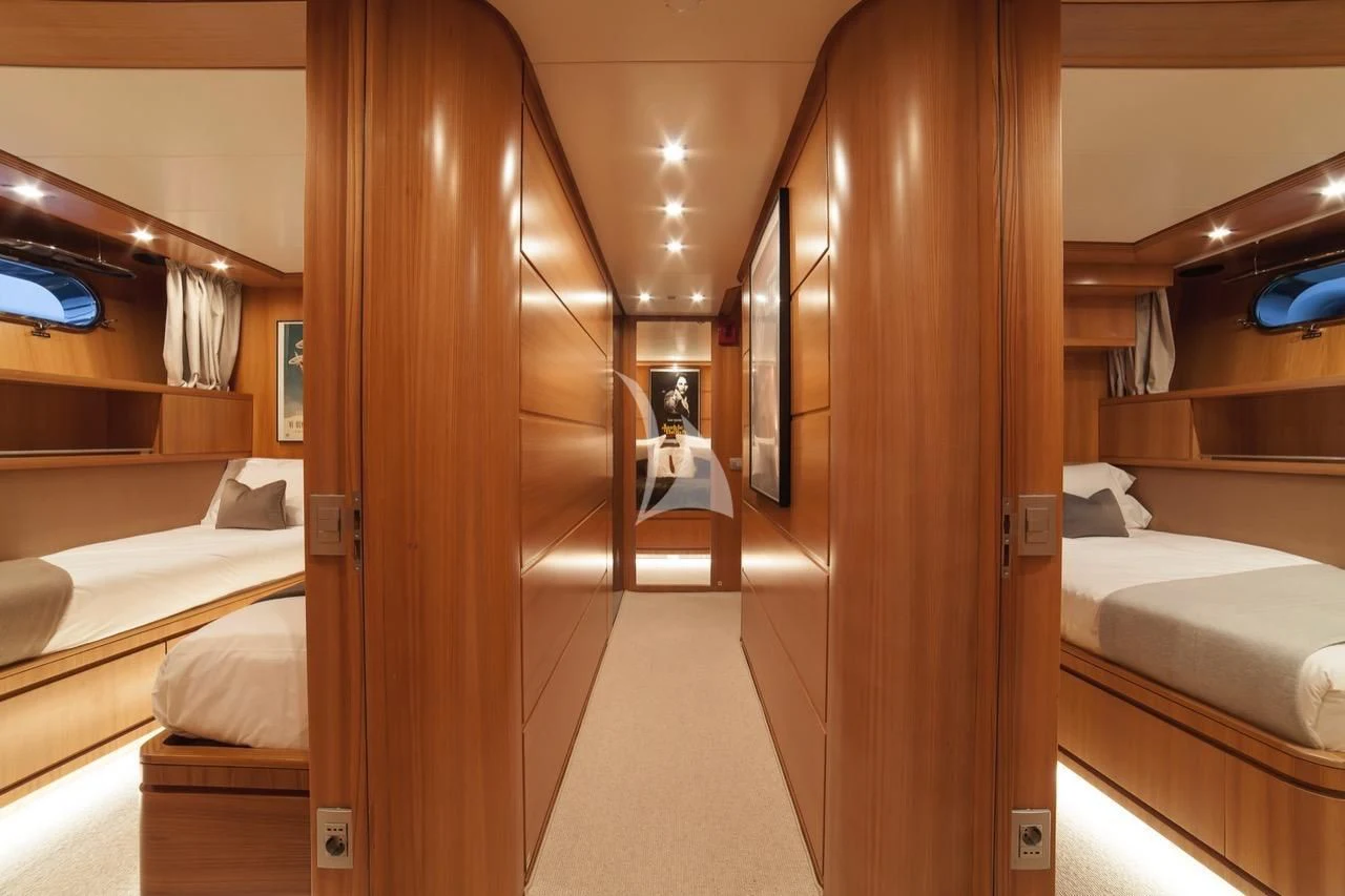 a room with a bed and a mirror aboard FASTER Yacht for Sale
