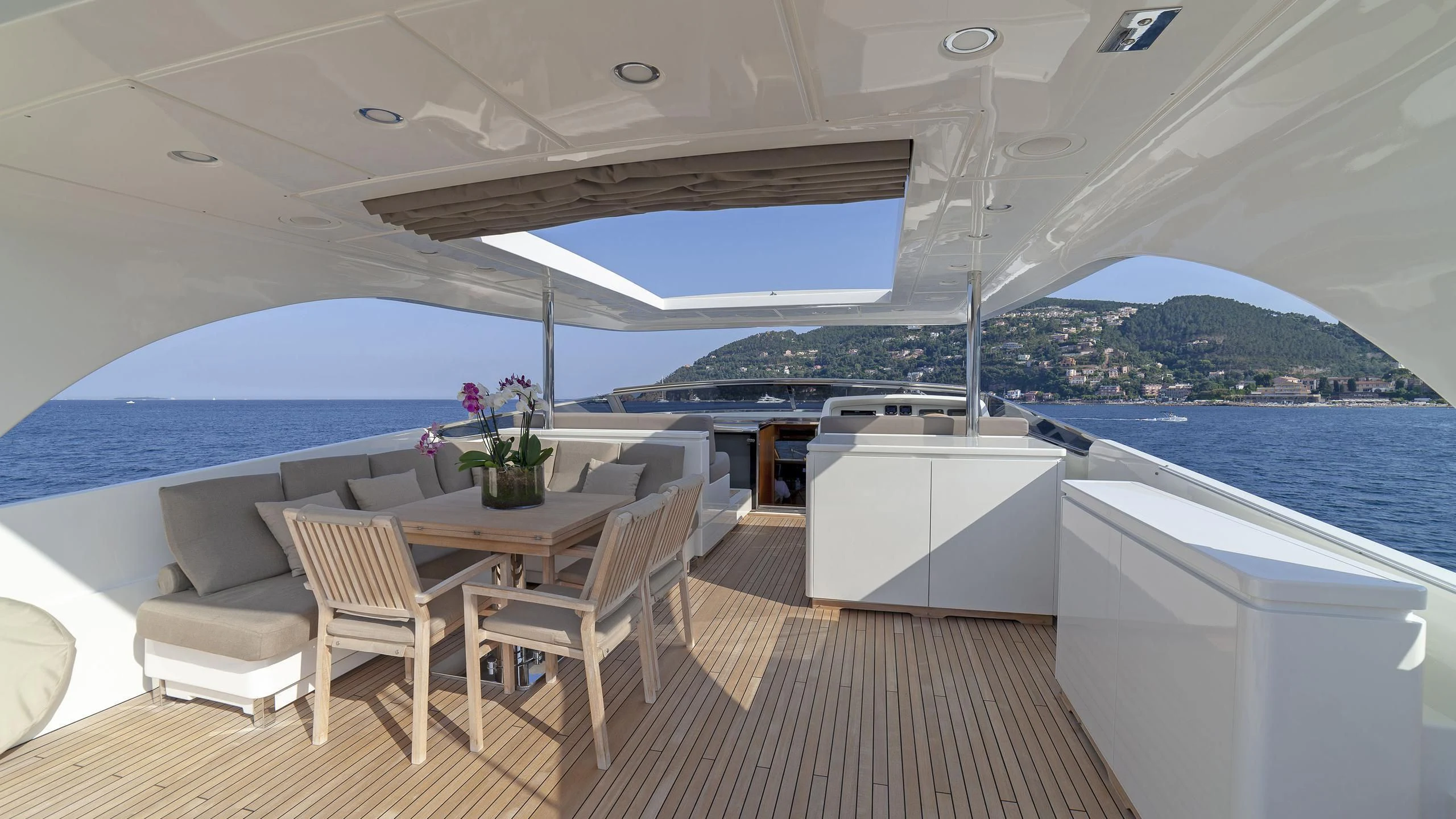 a room with a table and chairs aboard FASTER Yacht for Sale