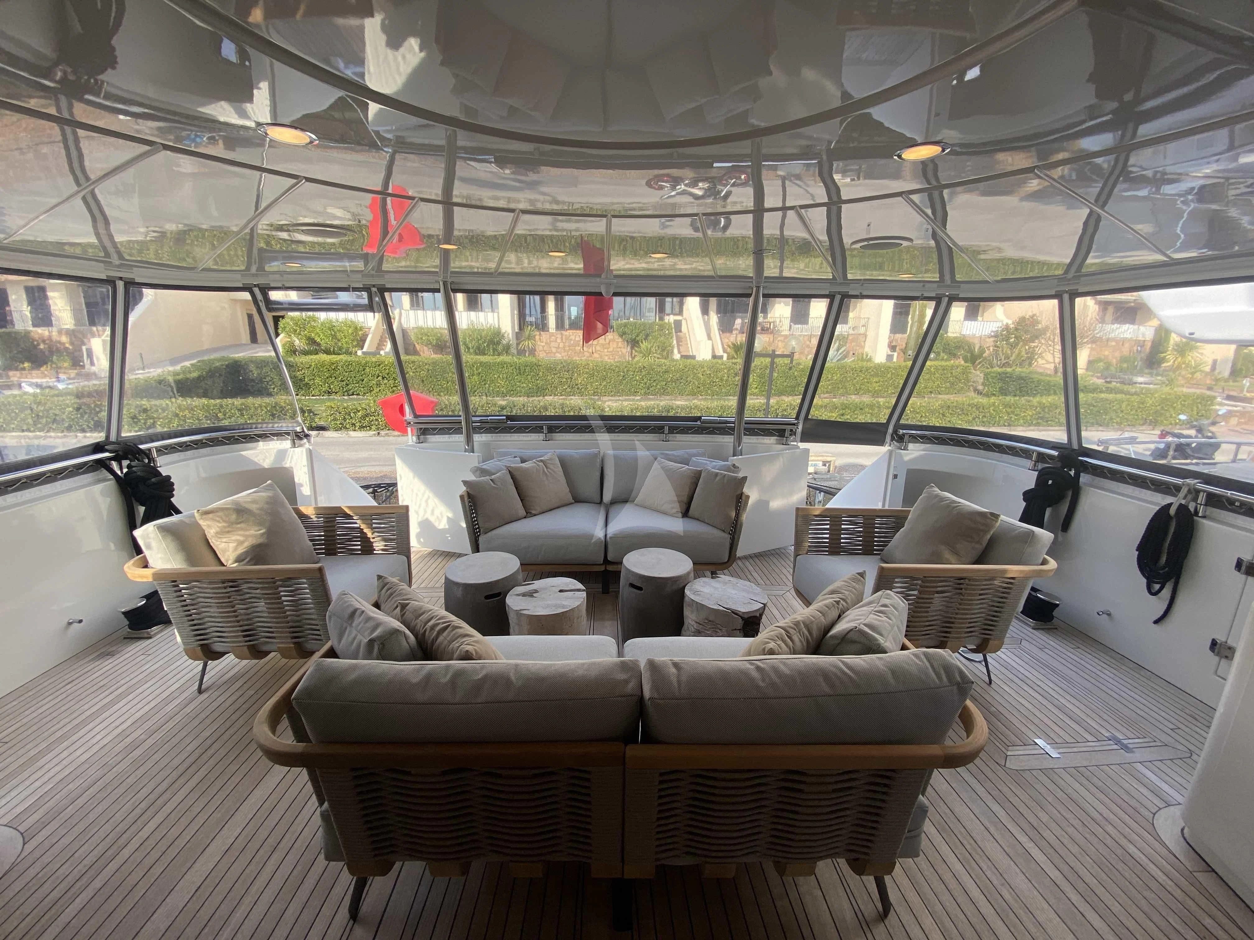 a room with a couch and chairs aboard FASTER Yacht for Sale
