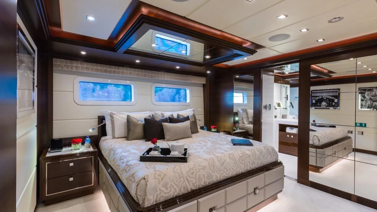 a bedroom with a bed and a desk aboard KING BABY Yacht for Sale
