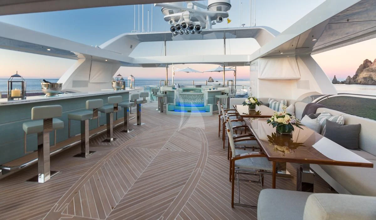 a large lounge area with a pool and a deck with a large lounge chair and a table and aboard KING BABY Yacht for Sale