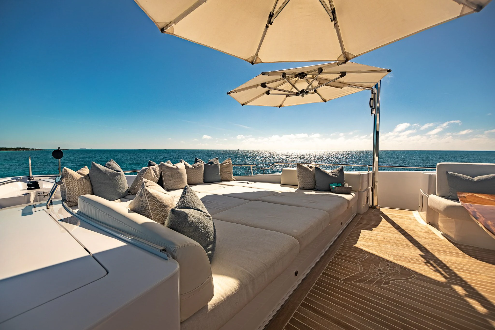 a large bed with a white couch and a large umbrella on a deck aboard KING BABY Yacht for Sale