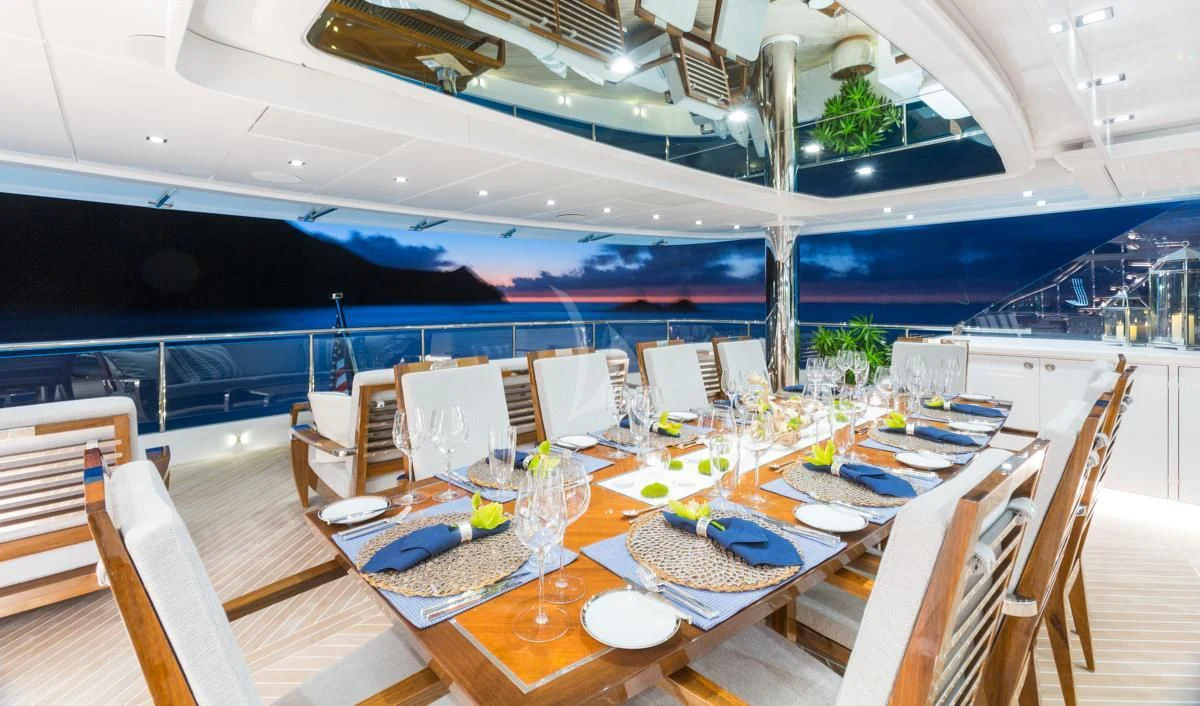 a large room with tables and chairs aboard KING BABY Yacht for Sale