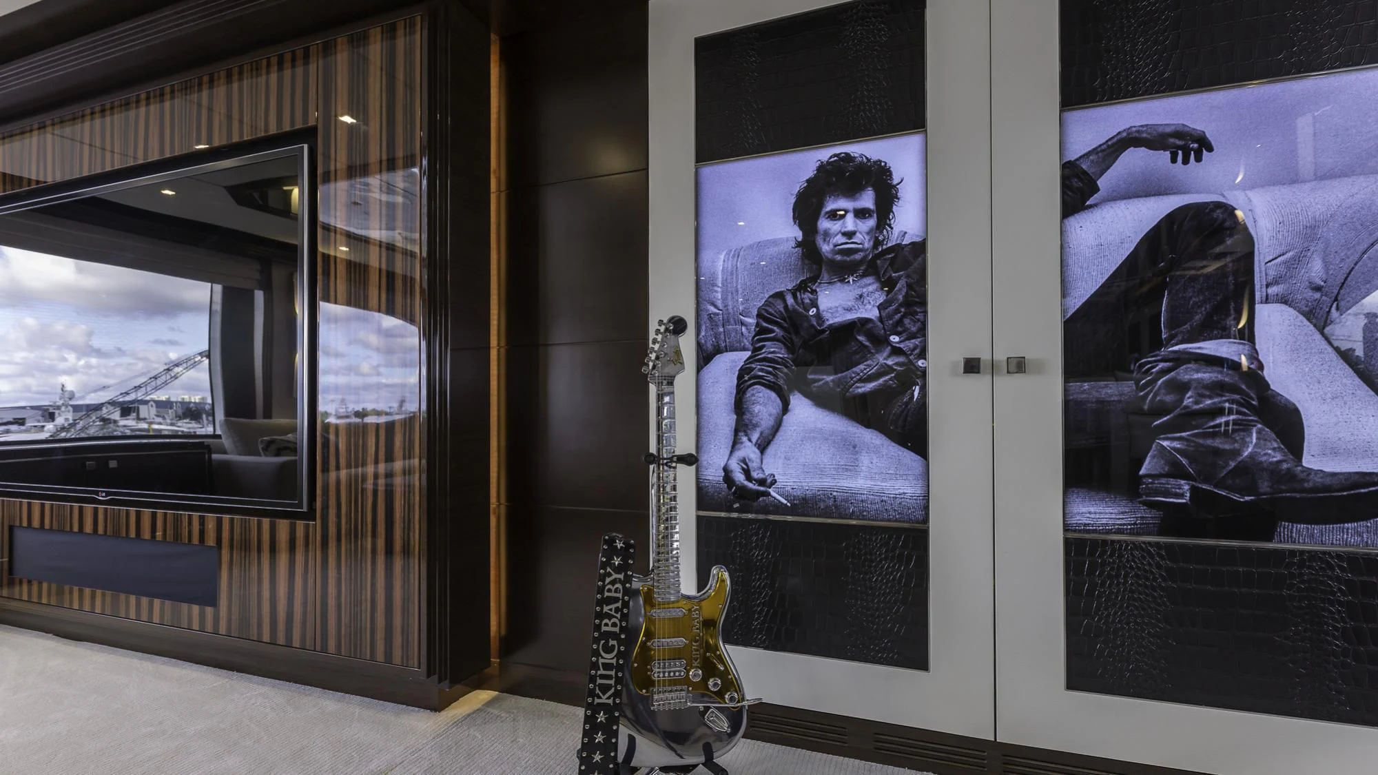 a display case with a guitar and a guitar in it aboard KING BABY Yacht for Sale