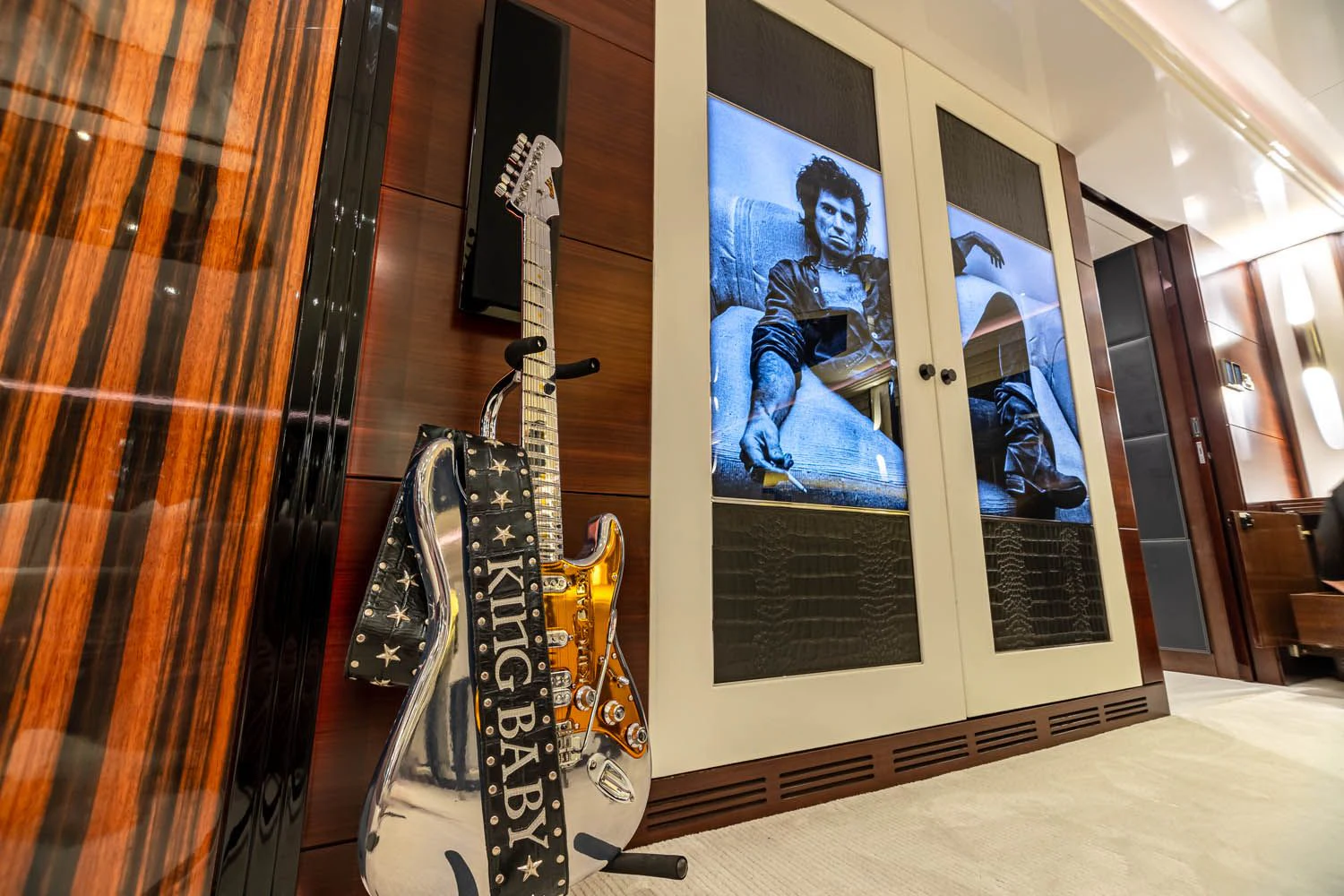 a guitar leaning against a wall aboard KING BABY Yacht for Sale