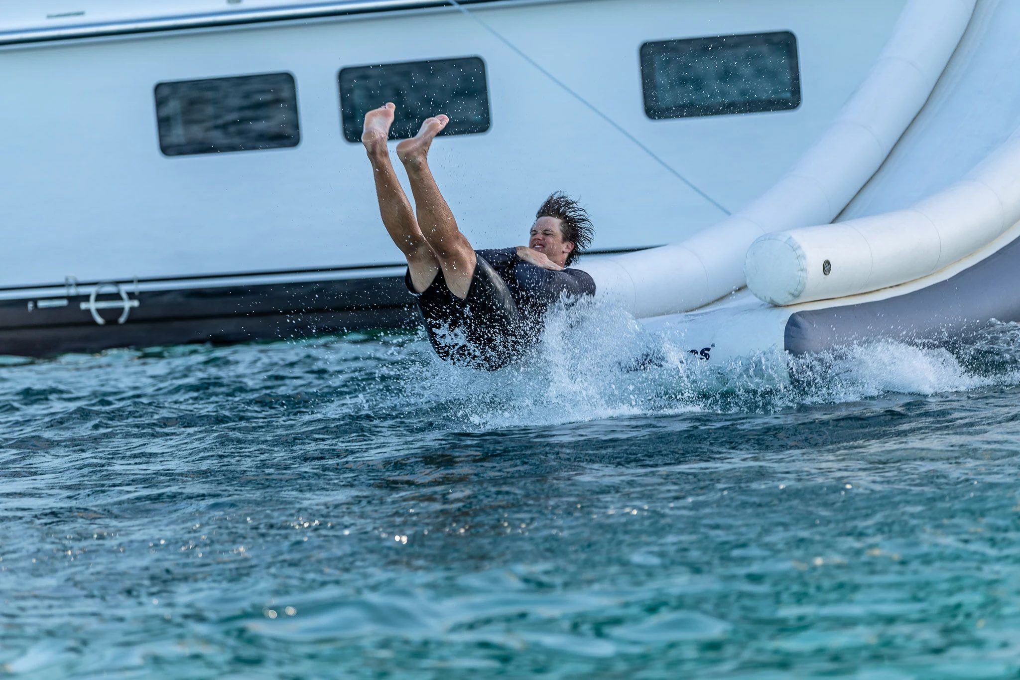 a man jumping out of a boat aboard KING BABY Yacht for Sale