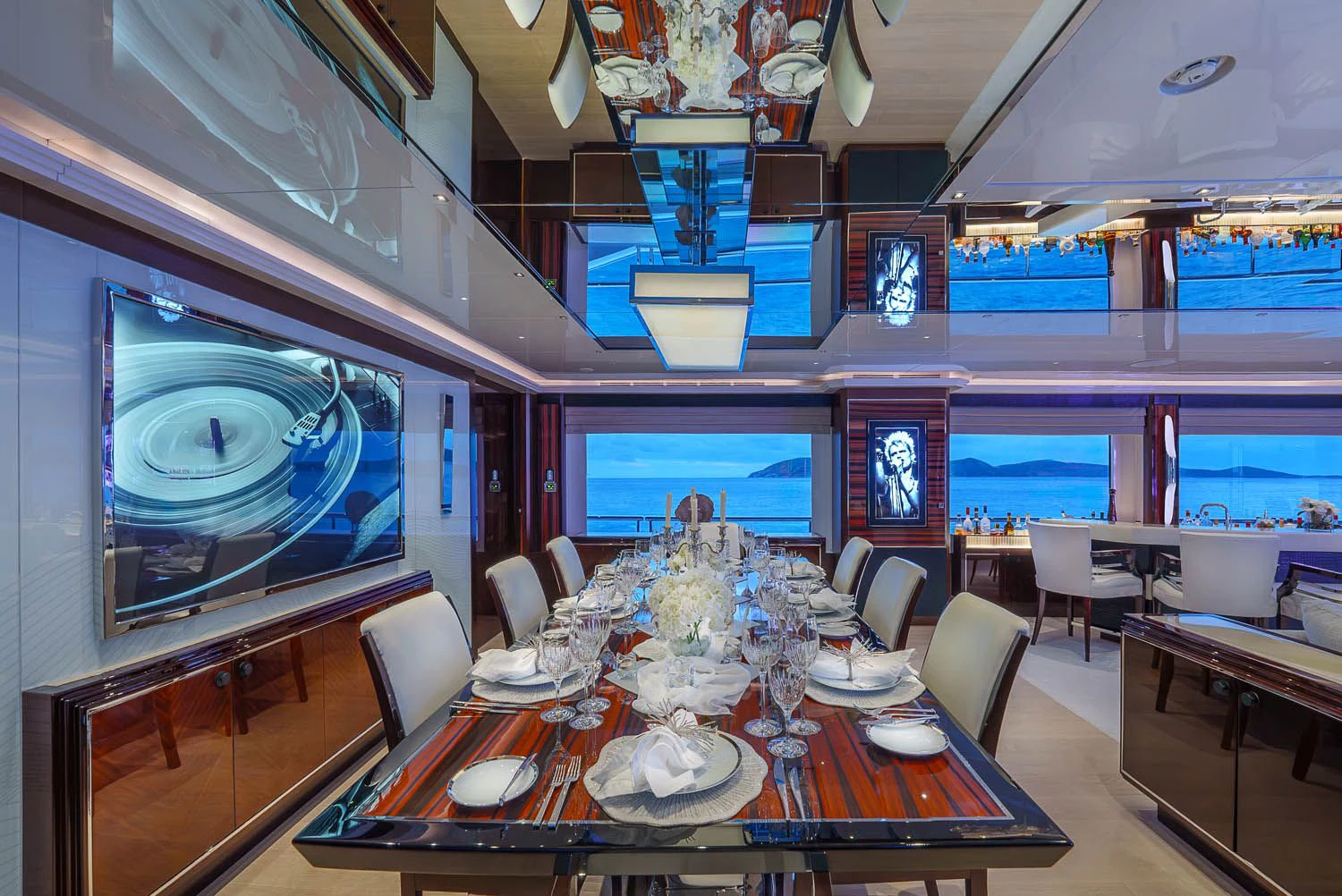 a dining room with a large screen aboard KING BABY Yacht for Sale