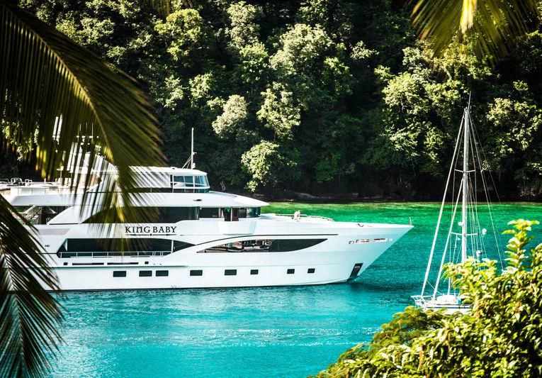 a boat in a tropical bay aboard KING BABY Yacht for Sale