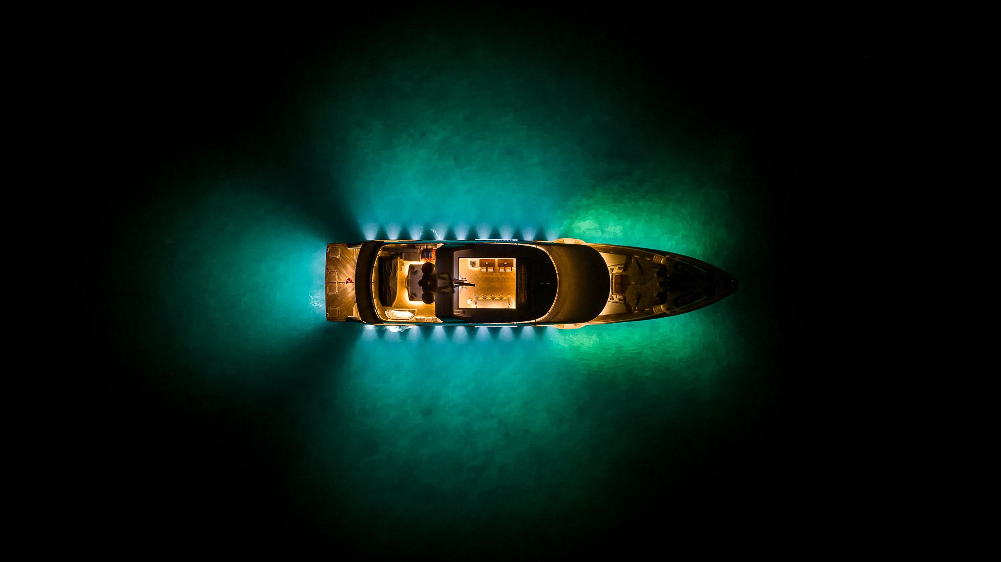 a gold lighter with a green background aboard KING BABY Yacht for Sale