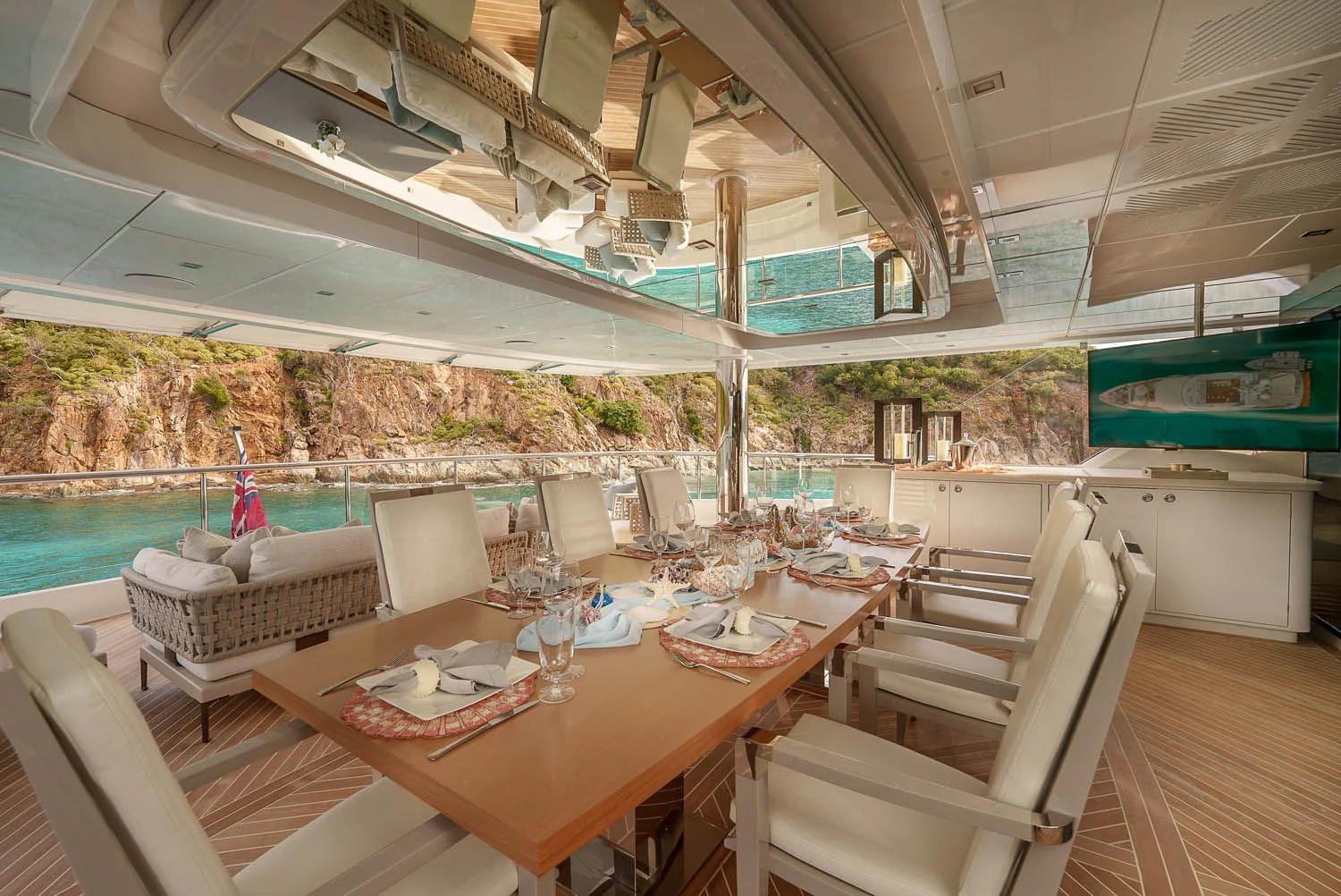 a table with chairs and a view of the water aboard KING BABY Yacht for Sale